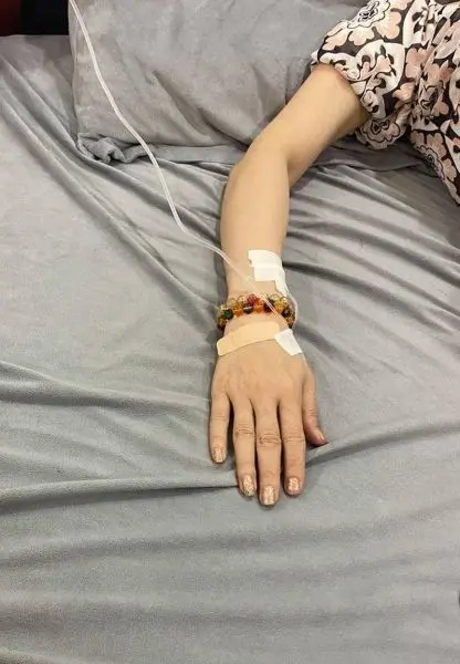 Ảnh truyền nước ở tay nữ với bàn tay nhẹ nhàng đặt trên giường Ảnh truyền nước ở tay nữ với bàn tay nhẹ nhàng đặt trên giường